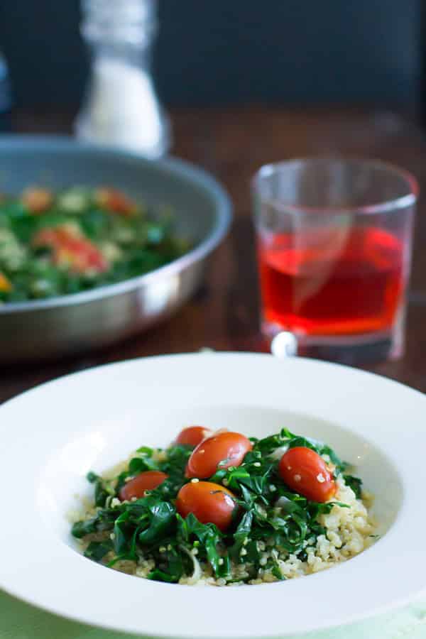 bowl with quinoa, collard greens, and tomatoes