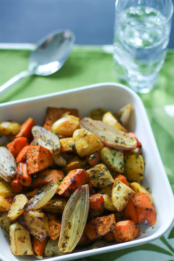 roasted root vegetables with thyme inside a white baking dish