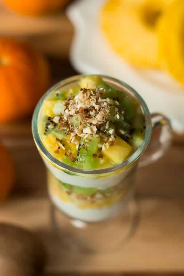 overhead view of kiwi pineapple parfait with chopped almonds on top