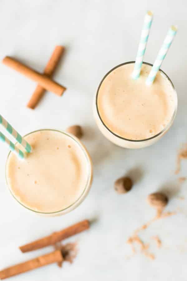 overhead view of two cups of pineapple and peach smoothie 