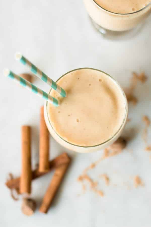 glass cup of Spicy Pineapple Peach Smoothie with straws inserted