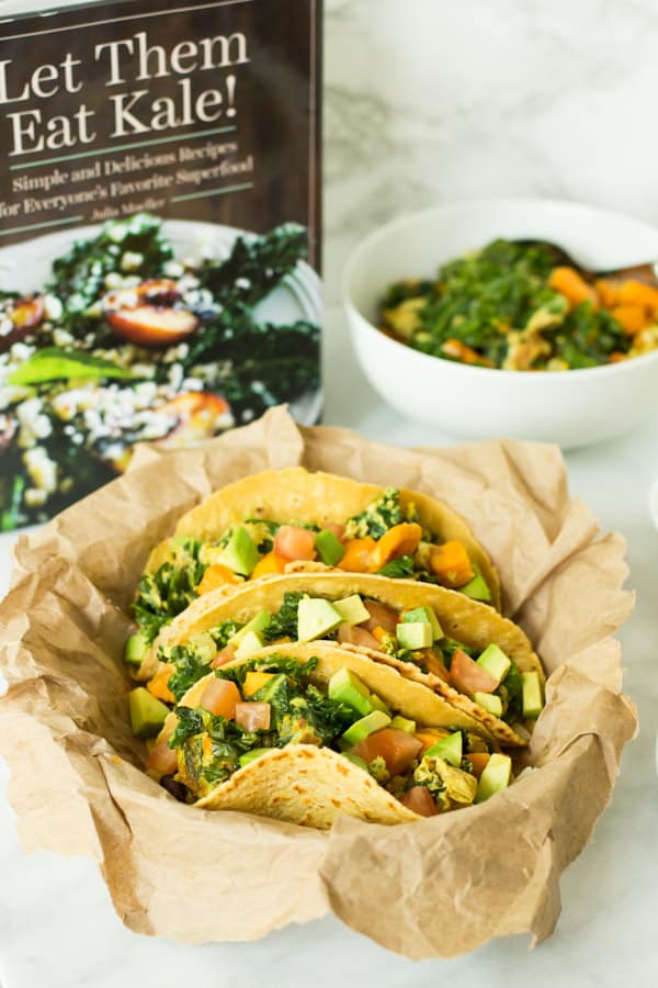 three Superfood Breakfast Tacos in front of Let Them Eat Kale cookbook