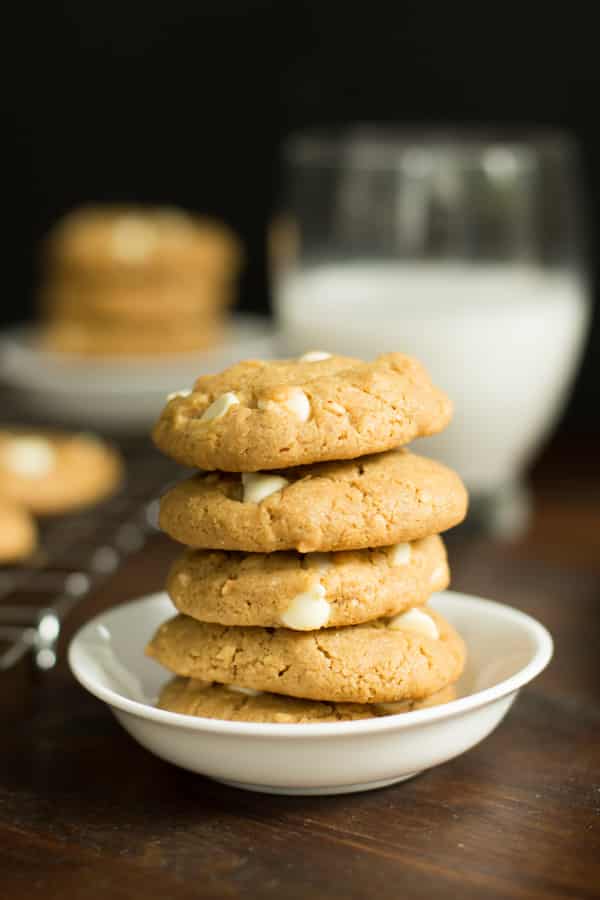 A stack of peanut butter chocolate white chip cookies in a white bowl.