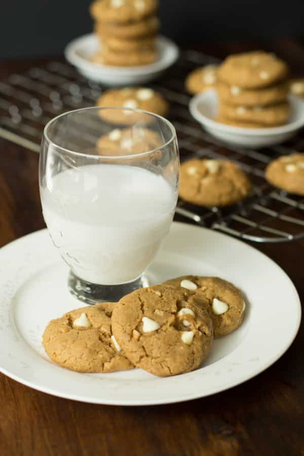Peanut Butter Chocolate White Chip Cookies on a plate with a cup of milk