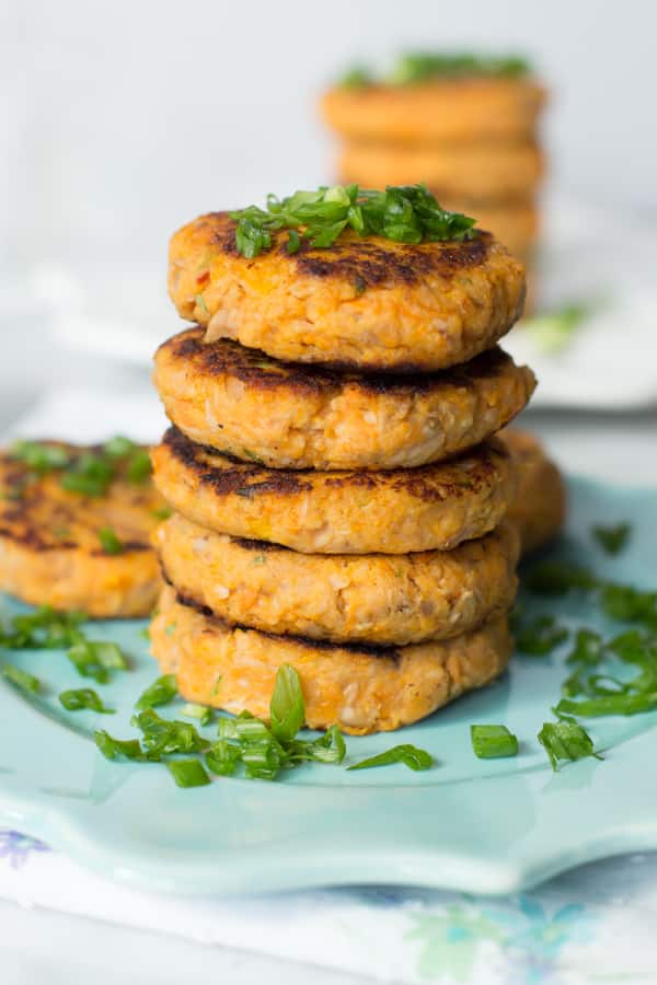 A stack of five sweet potato tuna patties on a plate.