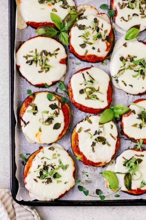 overhead view of eggplant pizza on a baking sheet