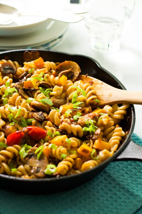 Fusilli with mushroom and roasted butternut squash being spooned.