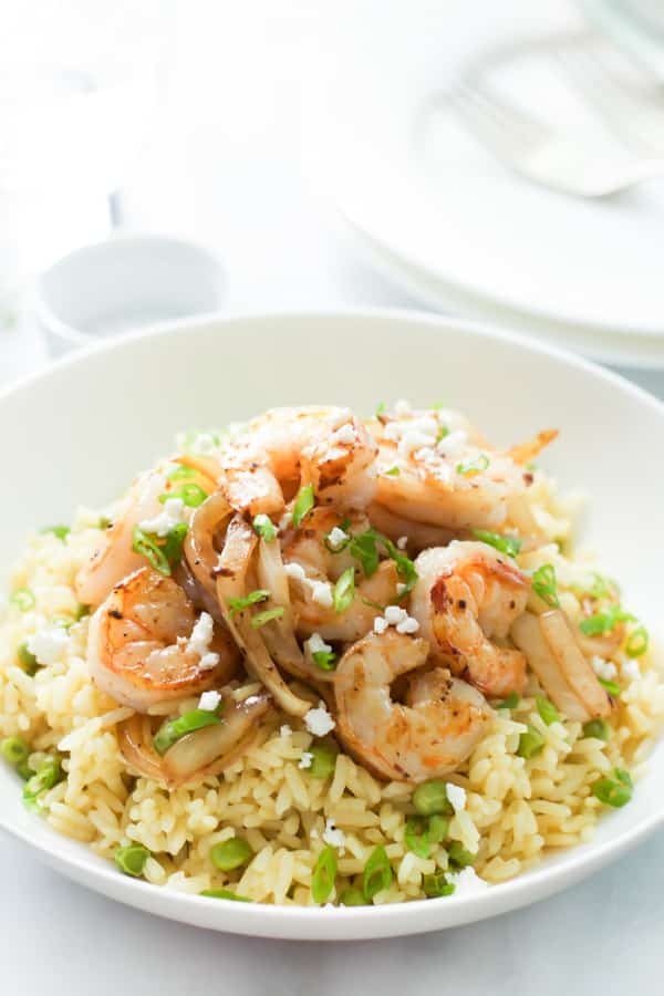 A bowl of rice with balsamic onions and shrimp.