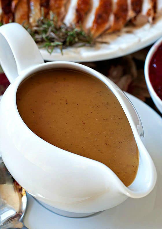 A gravy boat with turkey gravy.