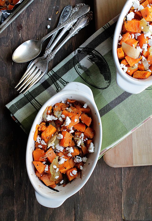Two serving bowls of sweet potato hash with onions feta.