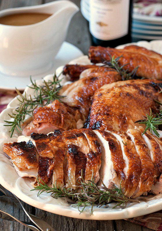 A roast turkey that has been cut up on a serving platter.