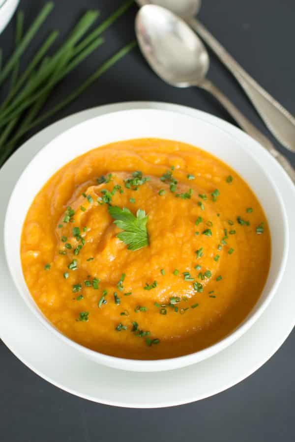 An overhead image of a bowl of carrot parsnip soup. 
