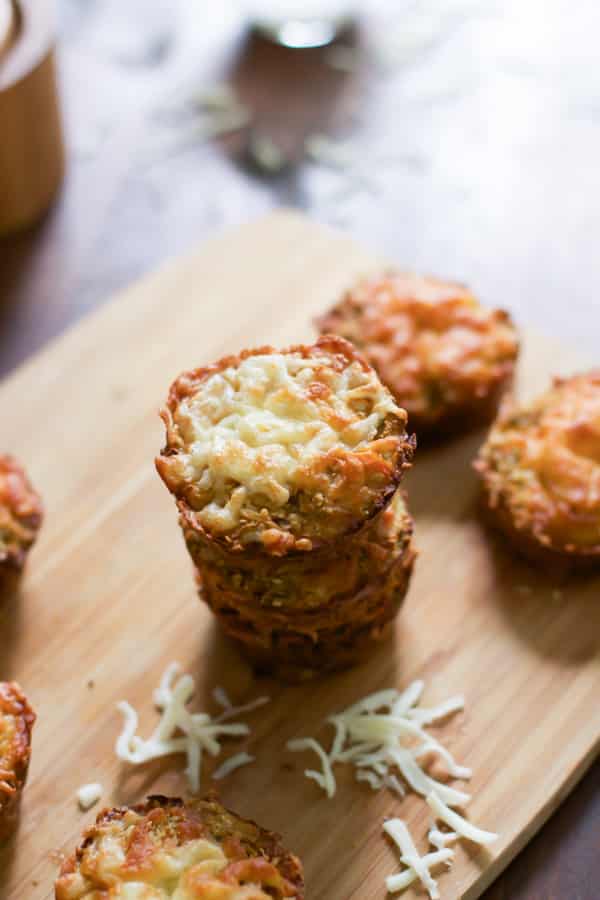 A stack of cauliflower muffins on a cutting board.