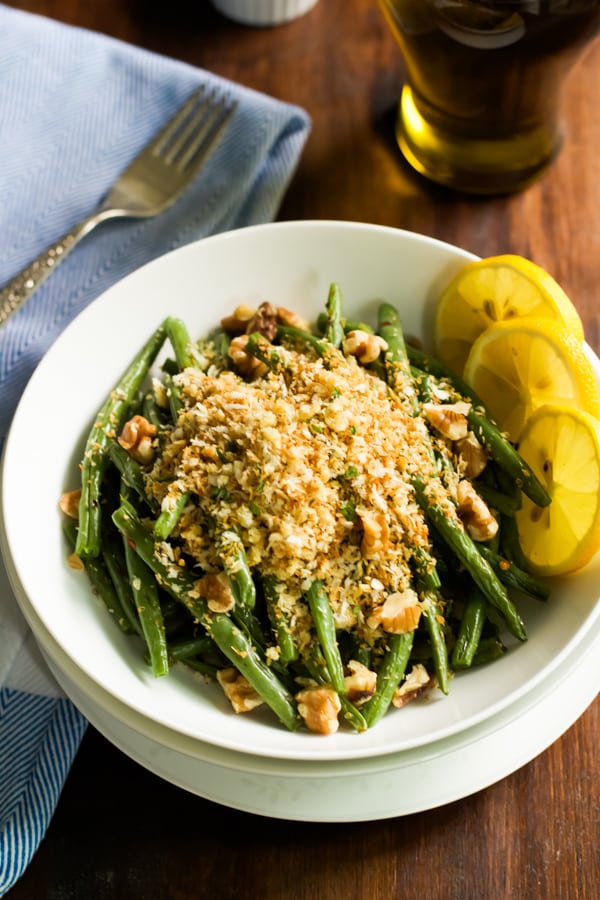 Overhead image of a bowl of roasted green beans with garlic panko.