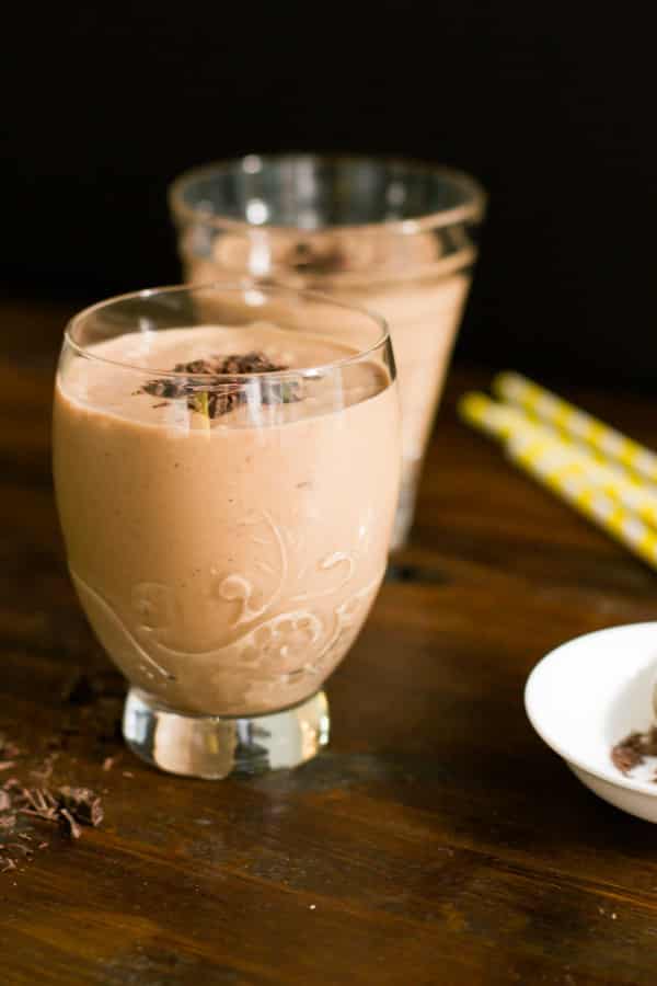 Two glass cups of chocolate peanut butter smoothie.