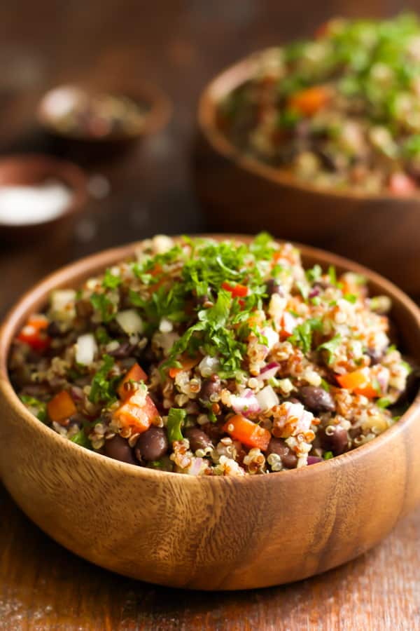 A wooden bowl of a quick and easy quinoa salad.