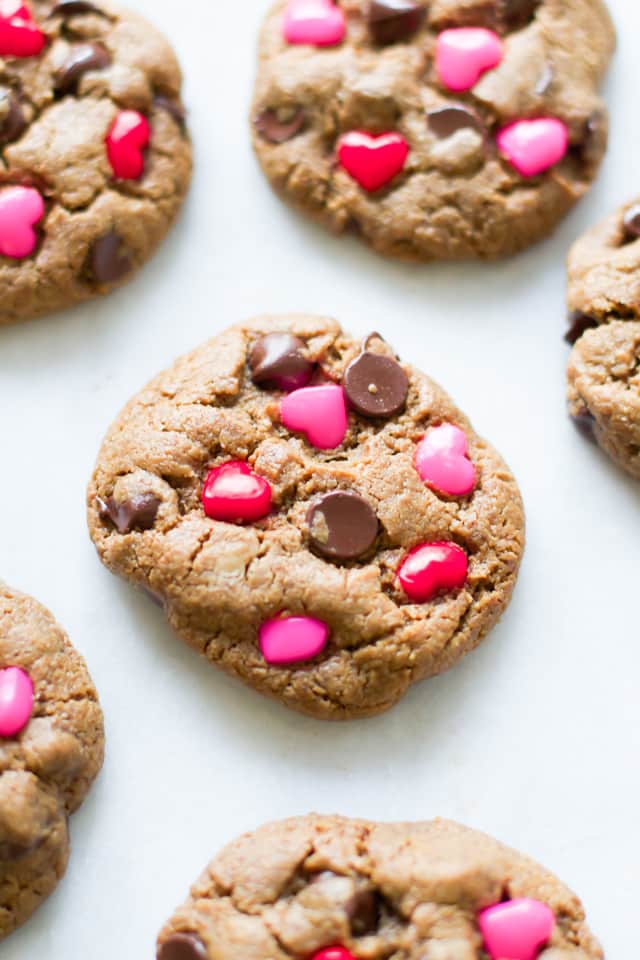 Overhead image of one Valentine’s Day Gluten Free Chocolate Chip Cookie in focus with the rest around it.
