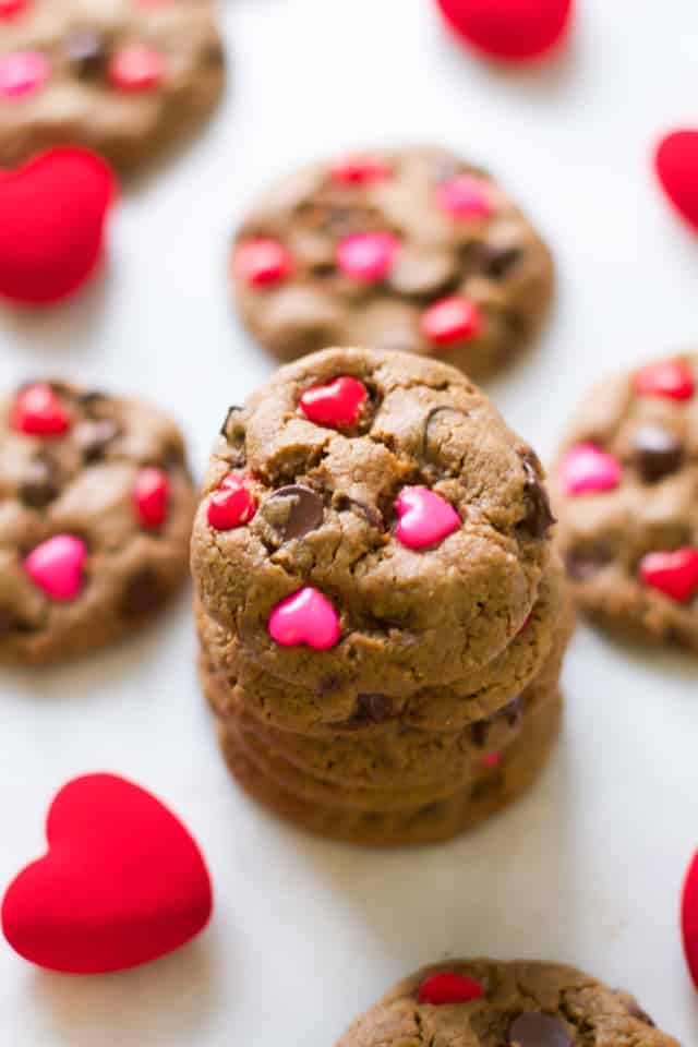 A stack of cookies with valentine's hearts in them.