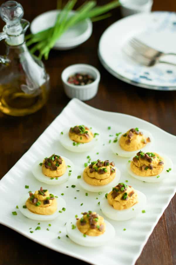 A white platter of lentil deviled eggs.