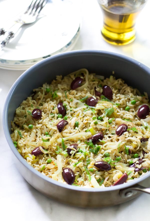 A bowl containing leek kalamata rice.