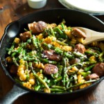 Sausage asparagus quinoa pasta in a cast iron skillet.