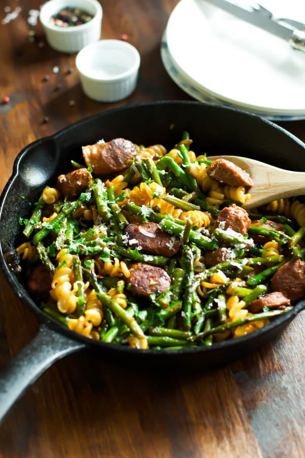 Sausage asparagus quinoa pasta in a cast iron skillet.