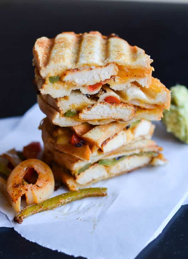 CHICKEN FAJITA GRILLED CHEESE A stack of chicken fajita grilled cheese cut in half.