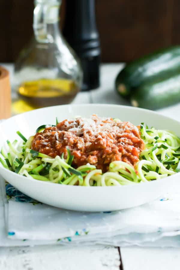 A bowl of zucchini noodles with turkey bolognese on top.