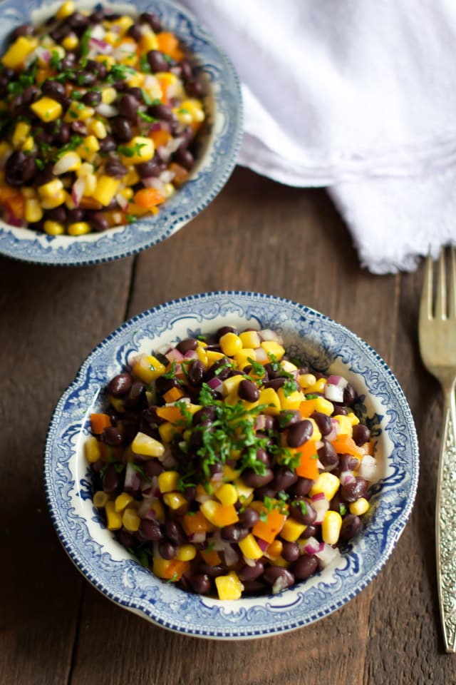An overhead photo of two bowls of black bean mango salad.