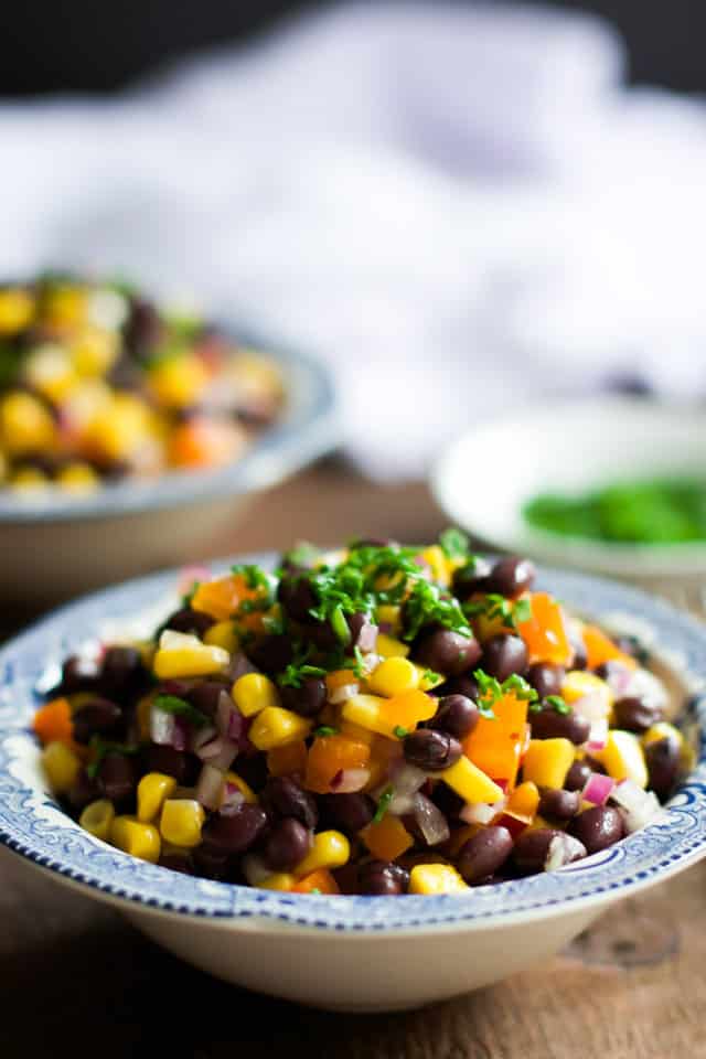 Close up of a black bean mango salad in a bowl.