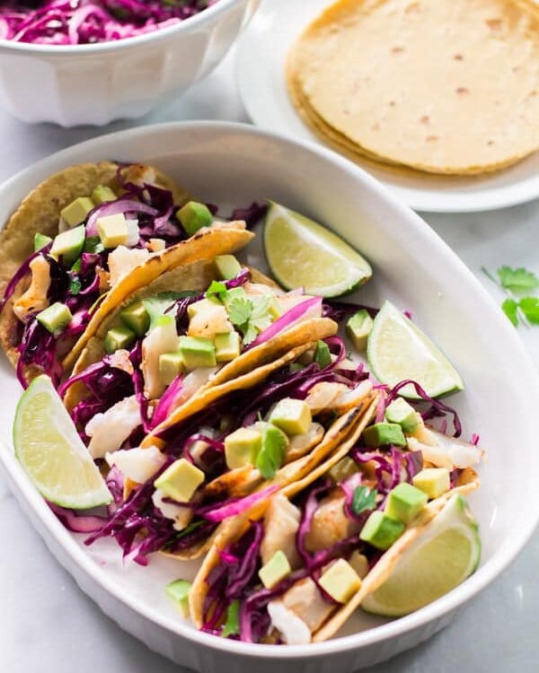 Overhead view of a platter containing Grilled Fish Tacos