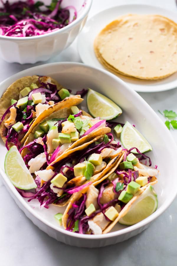 Overhead view of a platter containing Grilled Fish Tacos