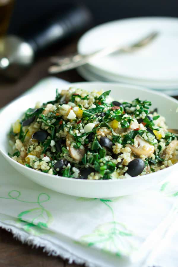 A bowl of kalamata collard quinoa salad.