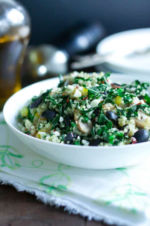 A bowl of kalamata collard quinoa salad.