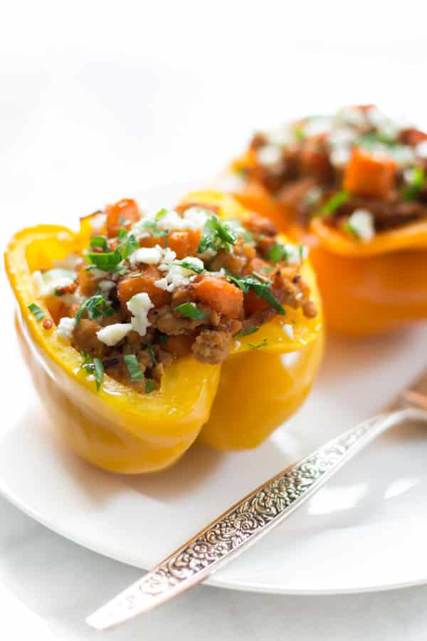 Close up of ground turkey sweet potato stuffed inside of a yellow bell pepper.