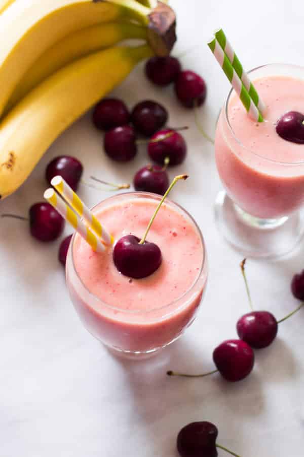 Energy smoothie - Overhead photo of two glasses of cherry pineapple smoothies.