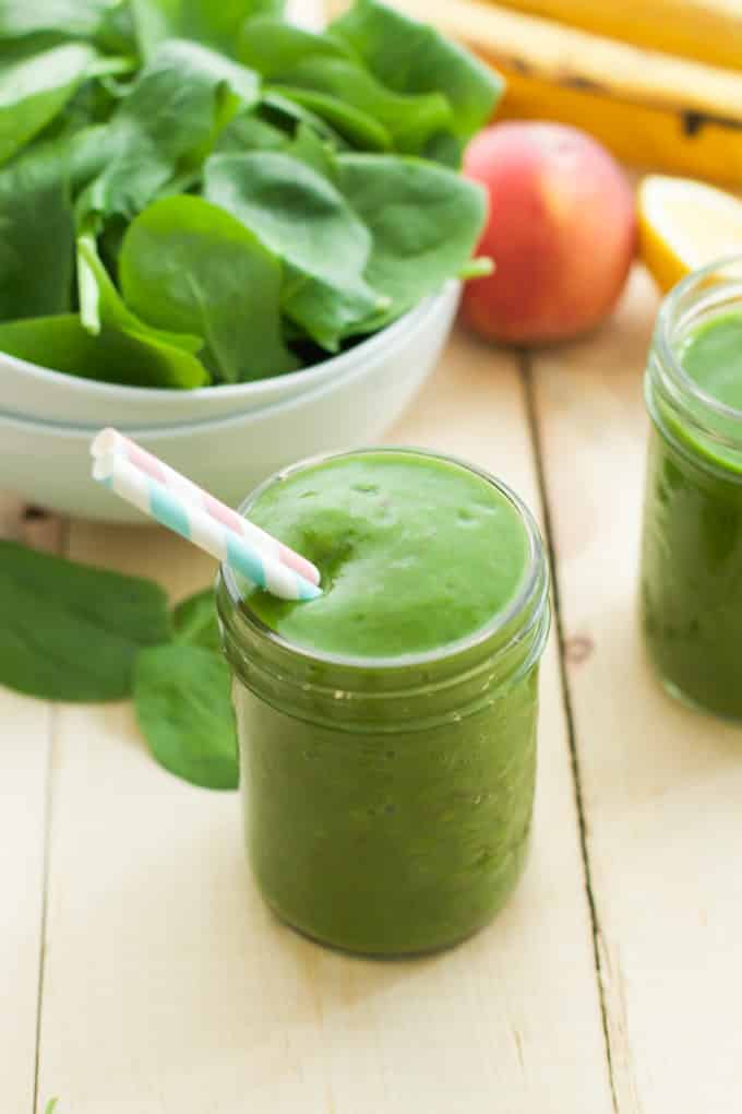 Close up of a mason jar of peach green smoothie.