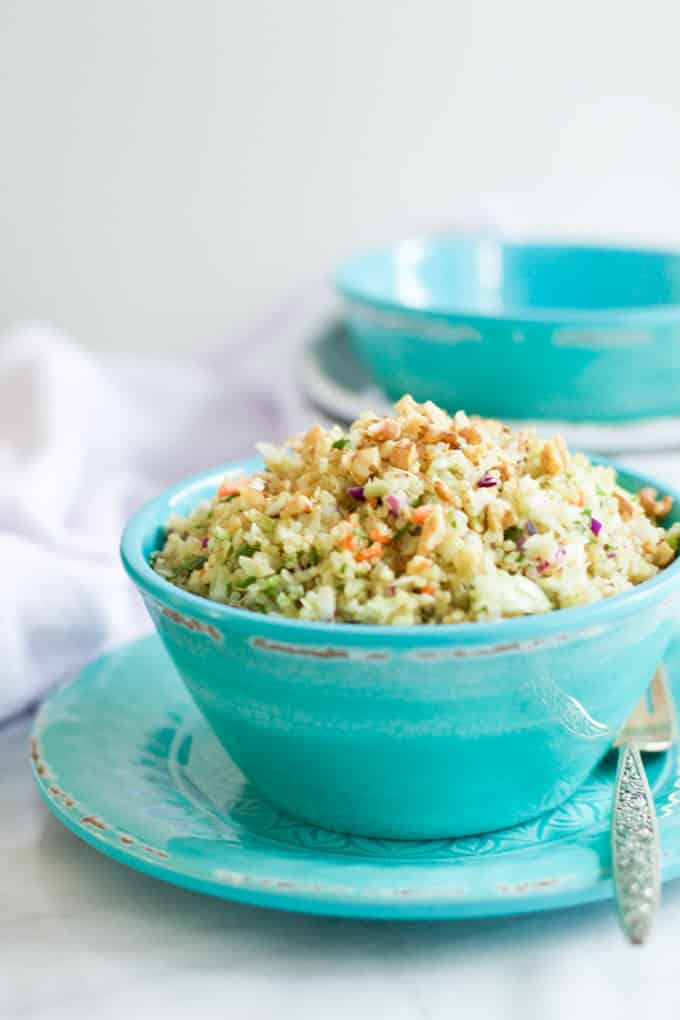 Straight-on photo of a teal bowl of quinoa cabbage salad.