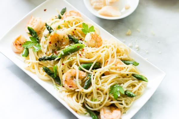 Overhead photo of a platter of garlic shrimp spaghetti.