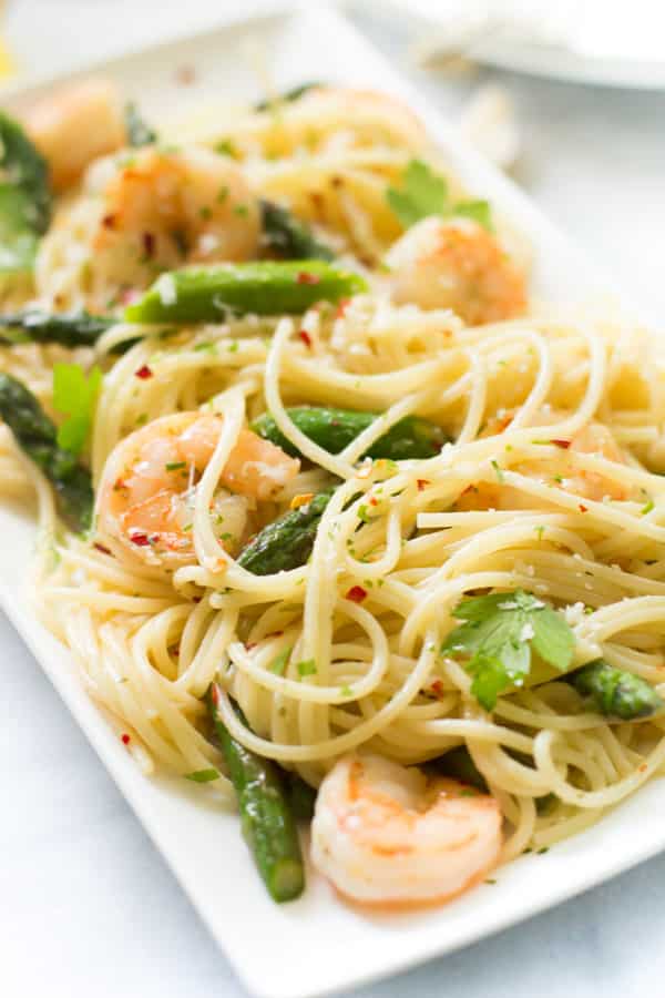 A close up of a platter of garlic shrimp spaghetti.