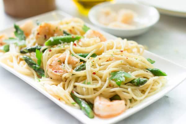 An angled image of a plate of garlic shrimp spaghetti.
