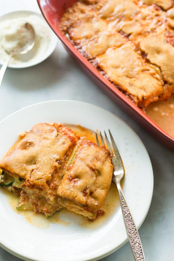 A plate with a slice of zucchini casserole and a fork.