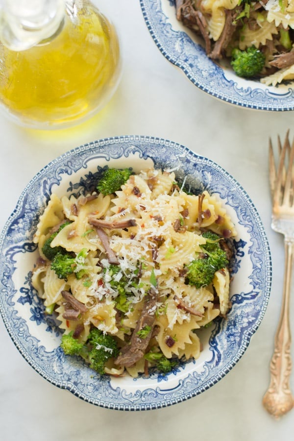 Close up of a bowl of leftover shredded roast beef pasta.