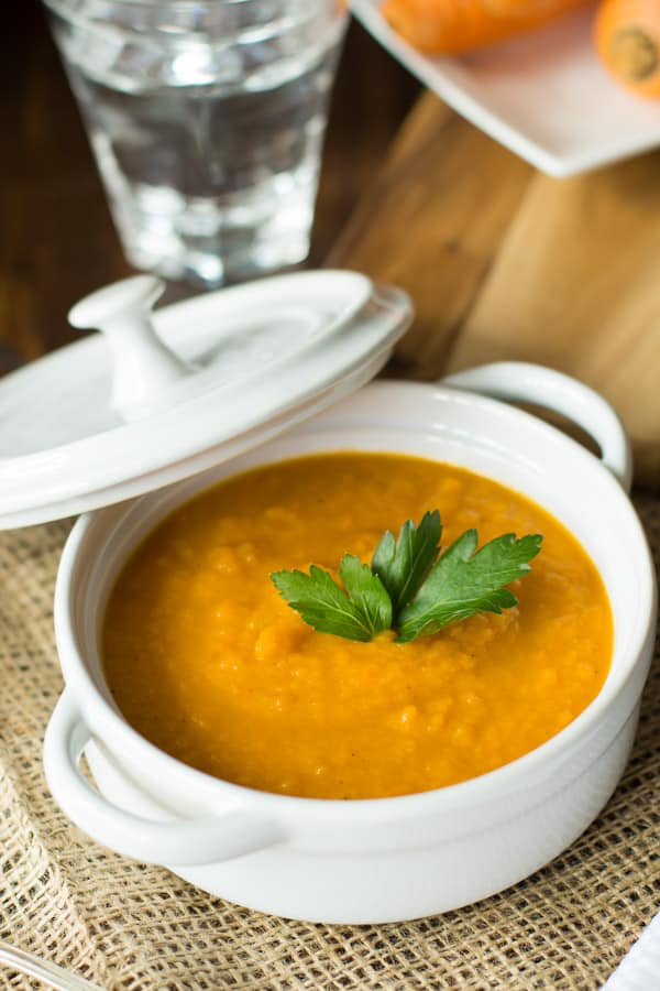 close up of a white bowl containing spicy carrot soup