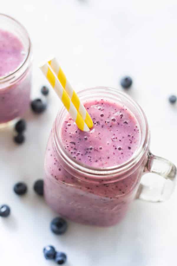 Overhead view of a mason jar of blueberry banana smoothie.