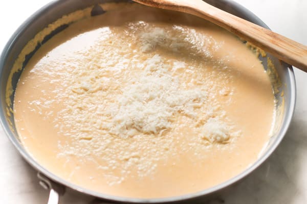 Photo showing parmesan cheese added to the sauce.