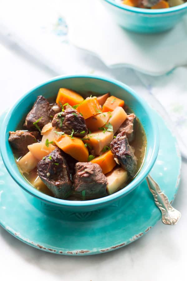 close-up of a stew recipe in a blue bowl