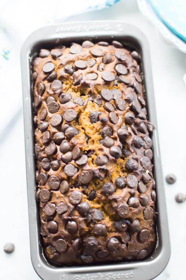 A loaf of pumpkin chocolate chip bread in the pan.