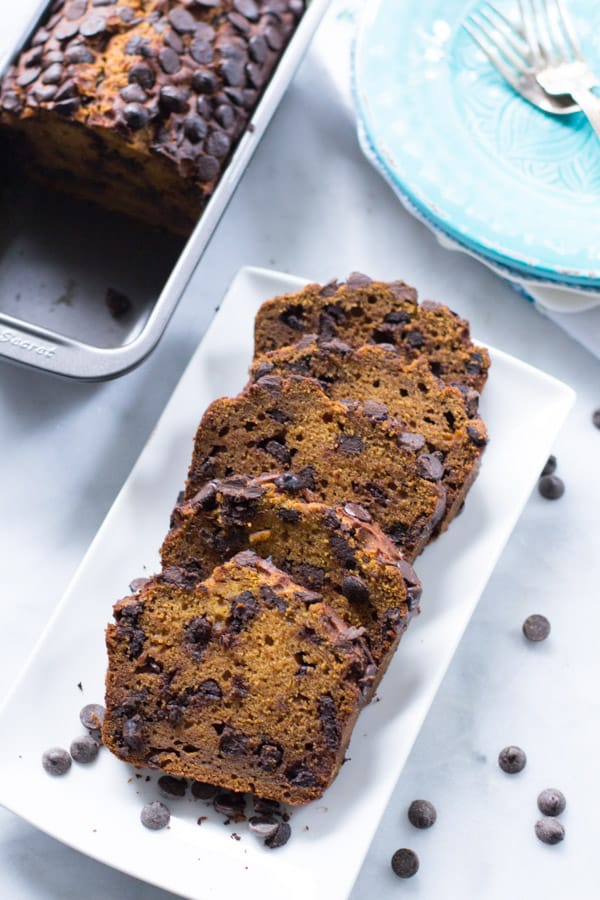 Five slices of pumpkin chocolate chip bread on a plate.