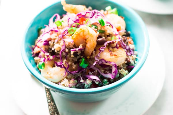 A blue bowl of shrimp quinoa salad.